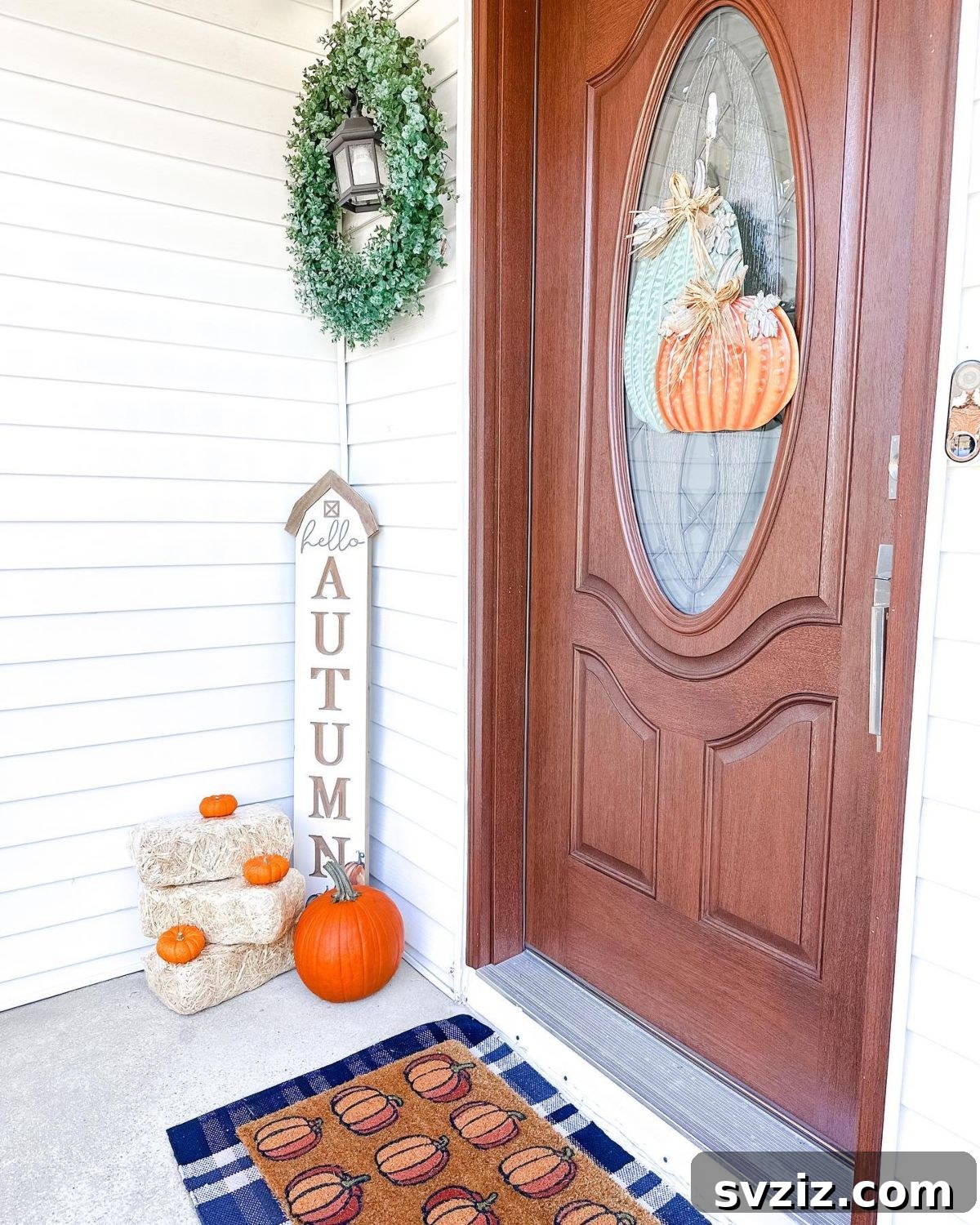 31 Autumn Outdoor Decor Ideas to Enhance Your Home's Curb Appeal 5 Rustic 'Hello Autumn' porch decor with orange pumpkins and fall foliage