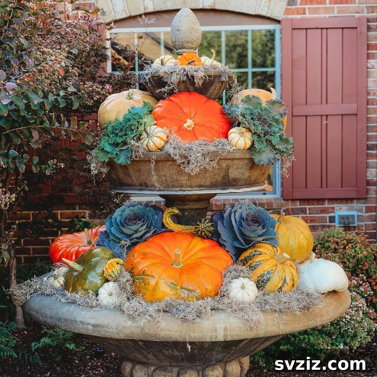 31 Autumn Outdoor Decor Ideas to Enhance Your Home's Curb Appeal 9 Outdoor fountain beautifully decorated with pumpkins and oversized fall florals