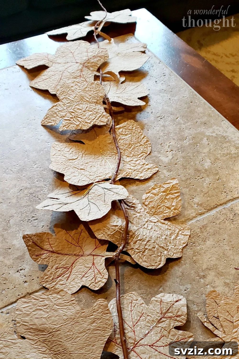 31 Chic Fall DIY Projects for Adult Homes 11 Handmade DIY fall leaf garland created from paper bags, a budget-friendly autumn decoration.