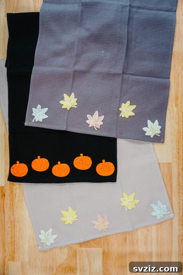 31 Chic Fall DIY Projects for Adult Homes 13 Easy DIY fall kitchen towel decorated with autumn-themed patches, adding seasonal charm to your kitchen.