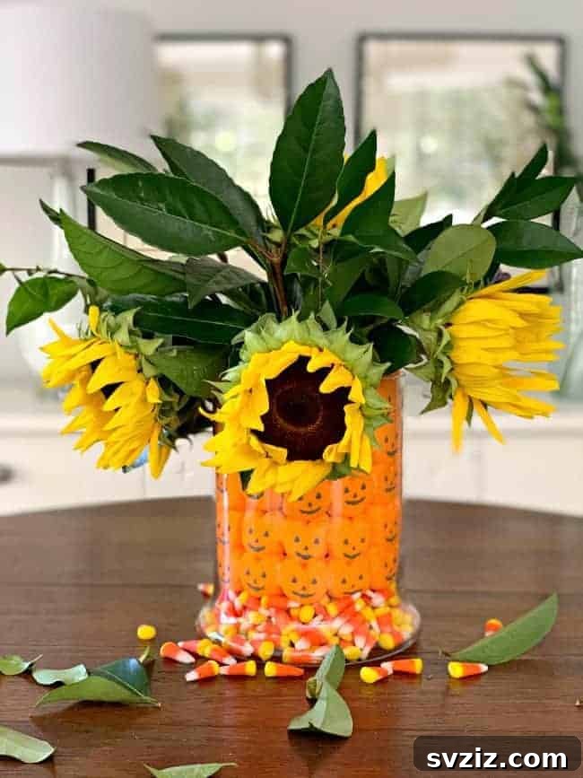 31 Chic Fall DIY Projects for Adult Homes 25 Festive DIY Halloween candy centerpiece with flowers and treats, perfect for seasonal celebrations.