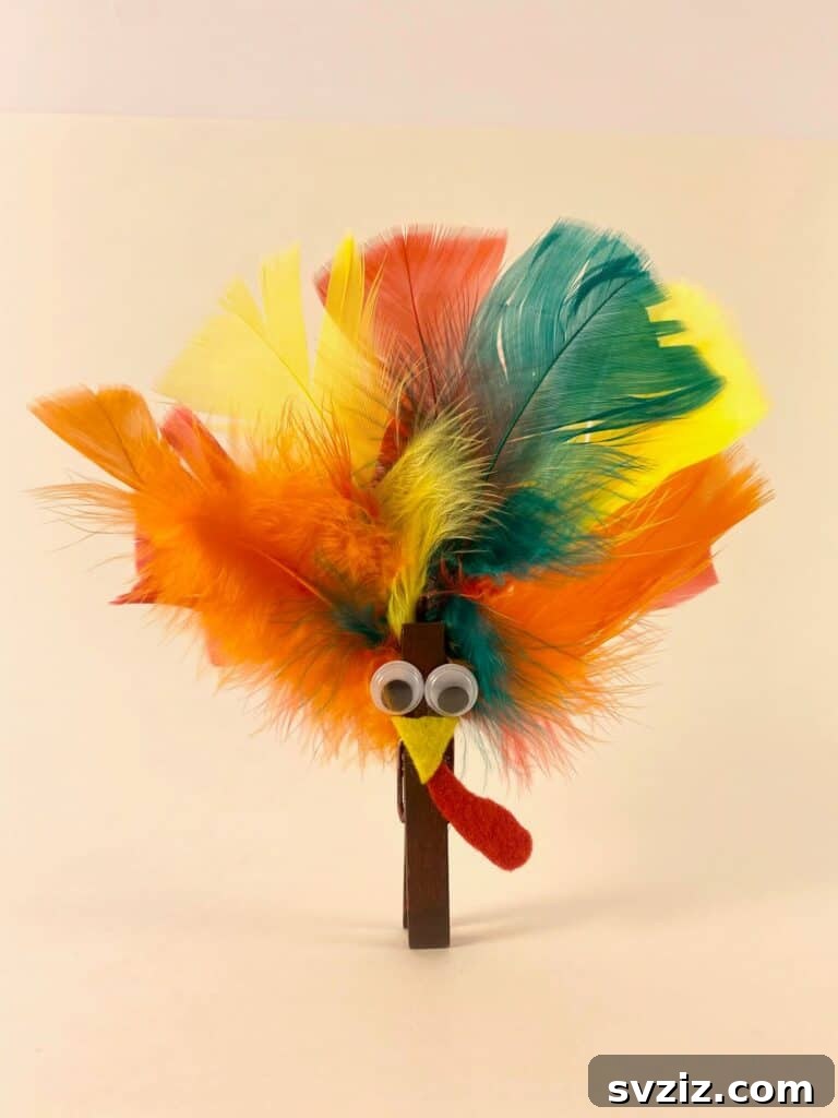 Clothespin Turkey with real feathers, a fun Thanksgiving craft for kids