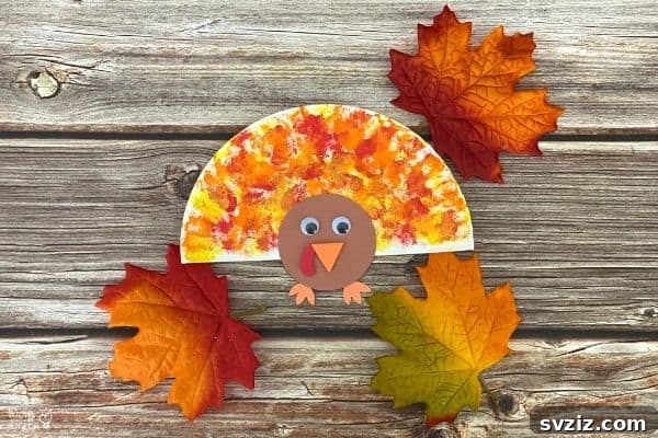 Kids' Cotton Ball Paper Plate Turkey craft with fall colors