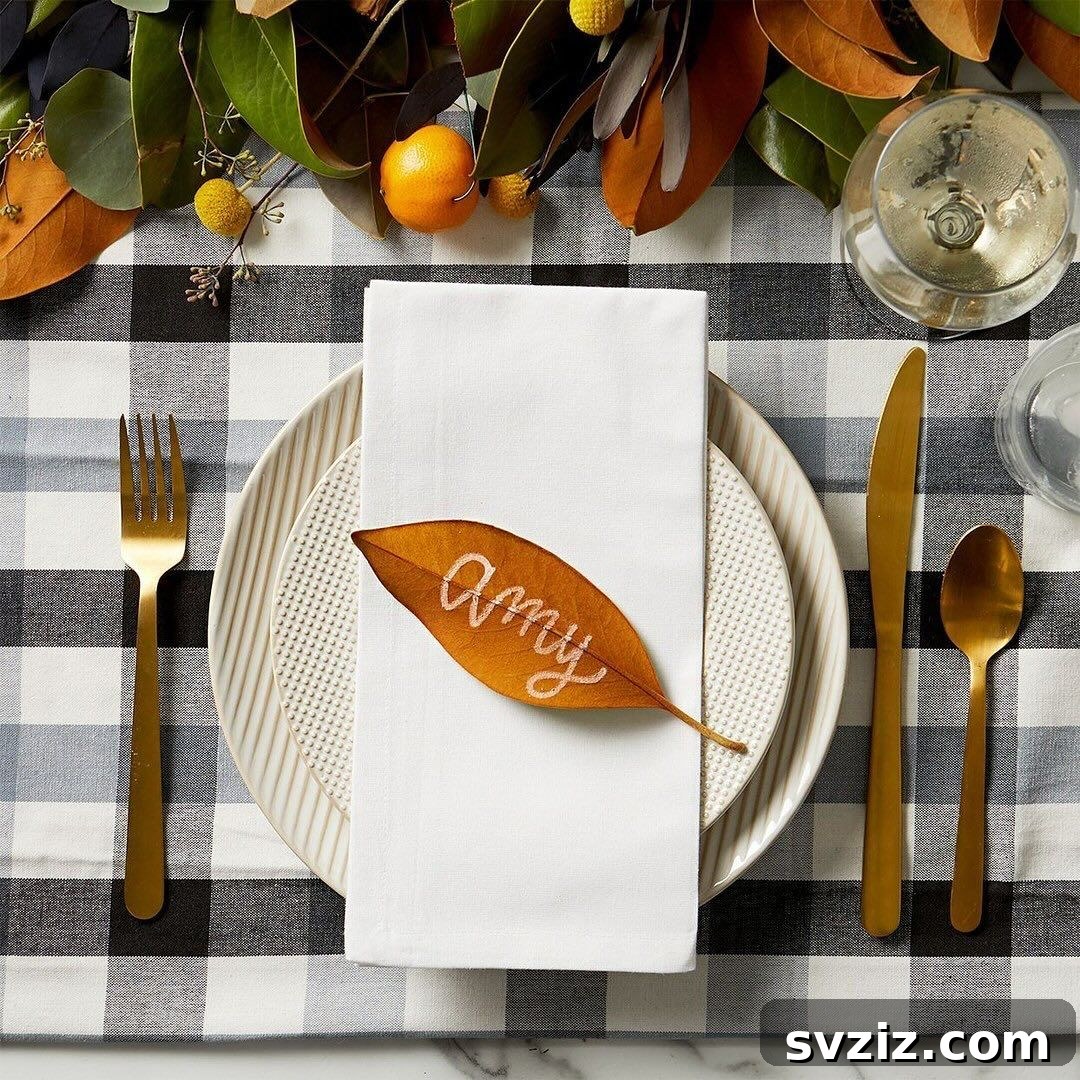 Craft the Perfect Feast: 21 DIY Thanksgiving Tablescapes 13 Simple and festive leaf place cards, handwritten with guest names, adding a natural touch to the Thanksgiving table.