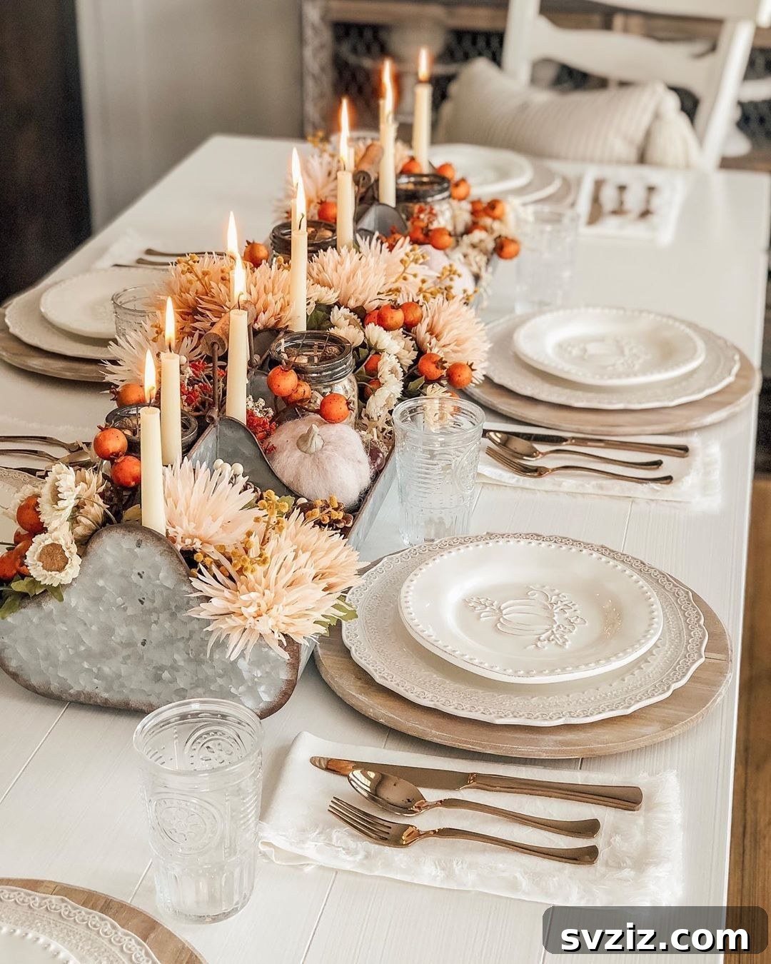 Craft the Perfect Feast: 21 DIY Thanksgiving Tablescapes 17 A classic and traditional Thanksgiving tablescape featuring a lush centerpiece of fall florals, pumpkins, and candles, creating a cozy and inviting tone.