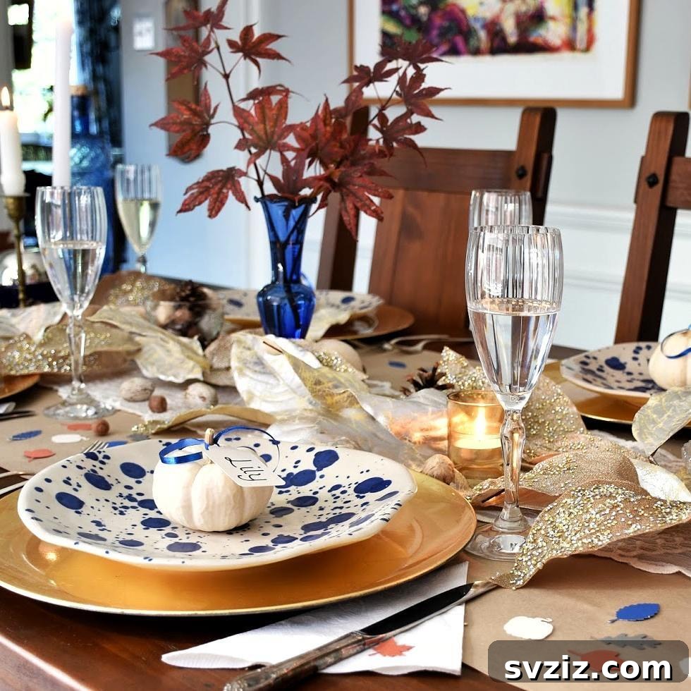 Craft the Perfect Feast: 21 DIY Thanksgiving Tablescapes 3 A stunning Thanksgiving tablescape featuring elegant blue plates, gold cutlery, and subtle autumn decorations, perfect for a sophisticated holiday dinner.