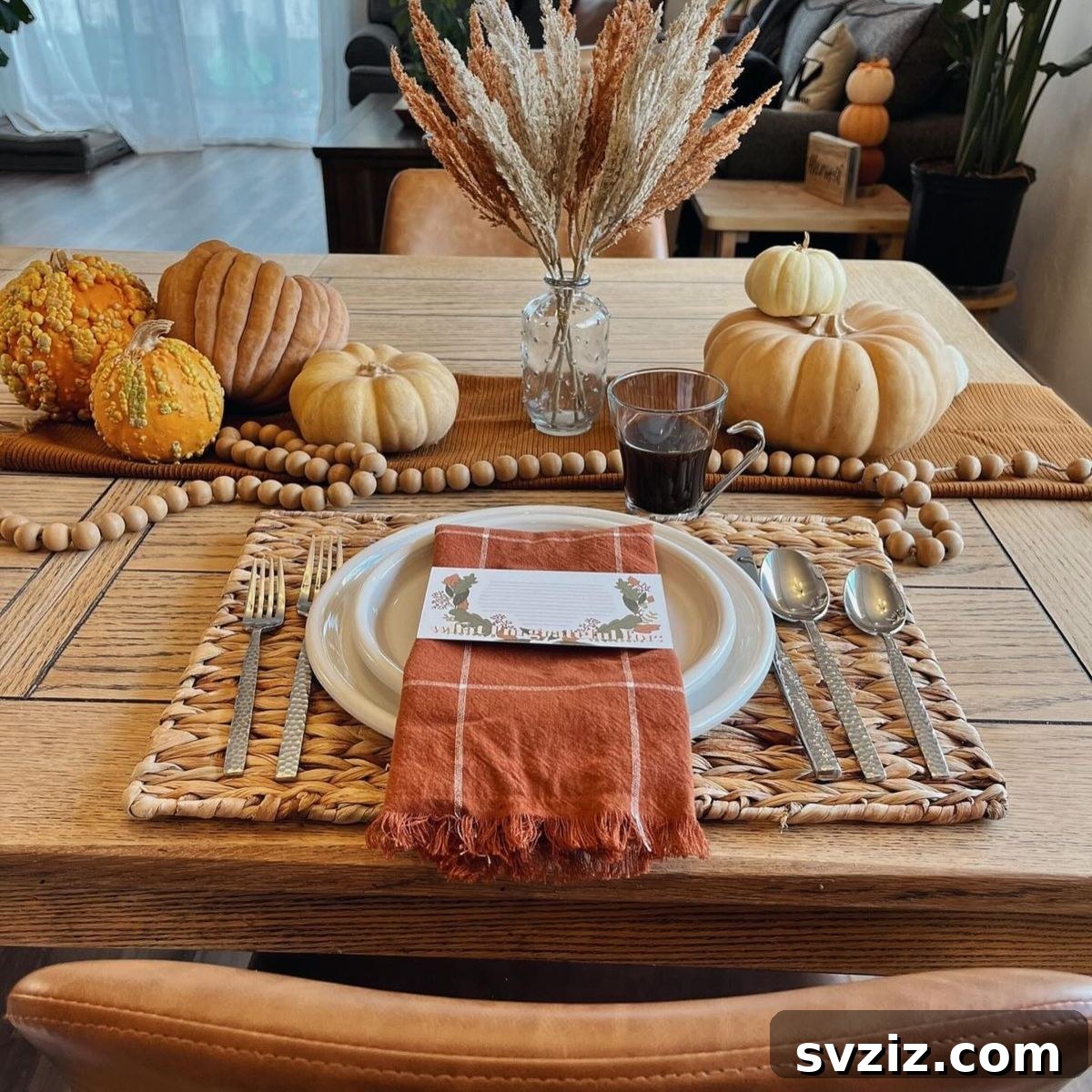 Craft the Perfect Feast: 21 DIY Thanksgiving Tablescapes 22 A charming Thanksgiving table set with festive fall decor and beautiful autumnal linens, including plaid napkins, creating a warm and inviting atmosphere.