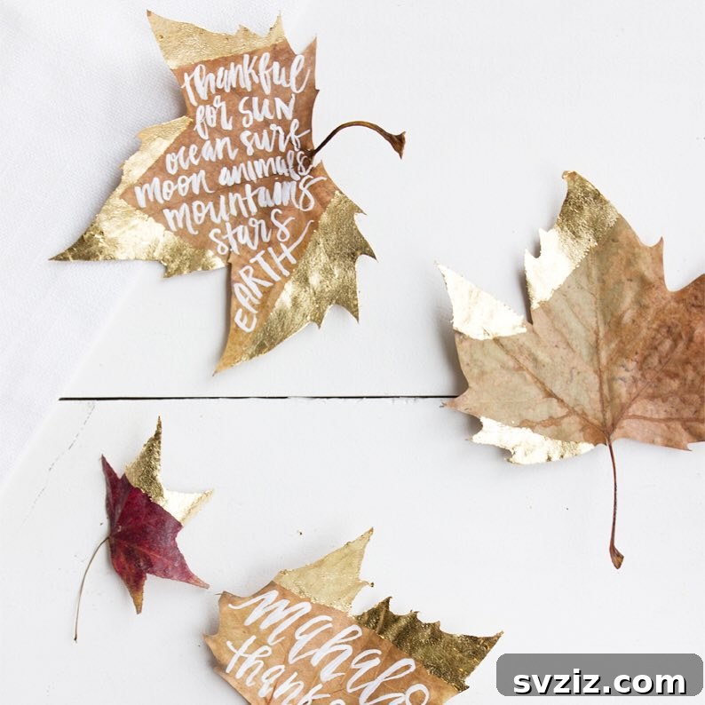 Craft the Perfect Feast: 21 DIY Thanksgiving Tablescapes 4 Handcrafted gold-dipped leaf place cards on a Thanksgiving table, inviting guests to write what they are thankful for.