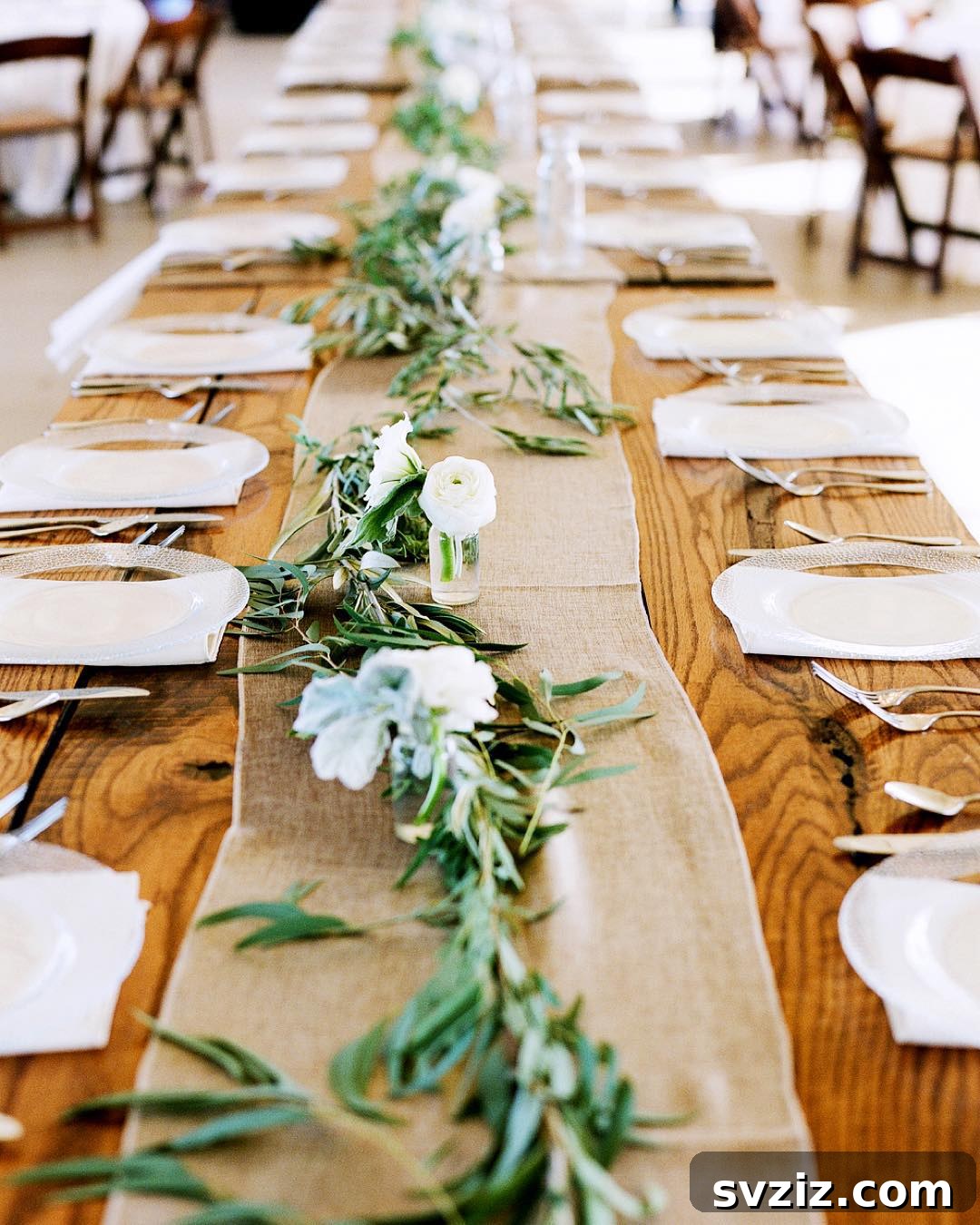 Craft the Perfect Feast: 21 DIY Thanksgiving Tablescapes 8 A long, elegant green table garland running down the center of a Thanksgiving table, creating a natural and inviting centerpiece.