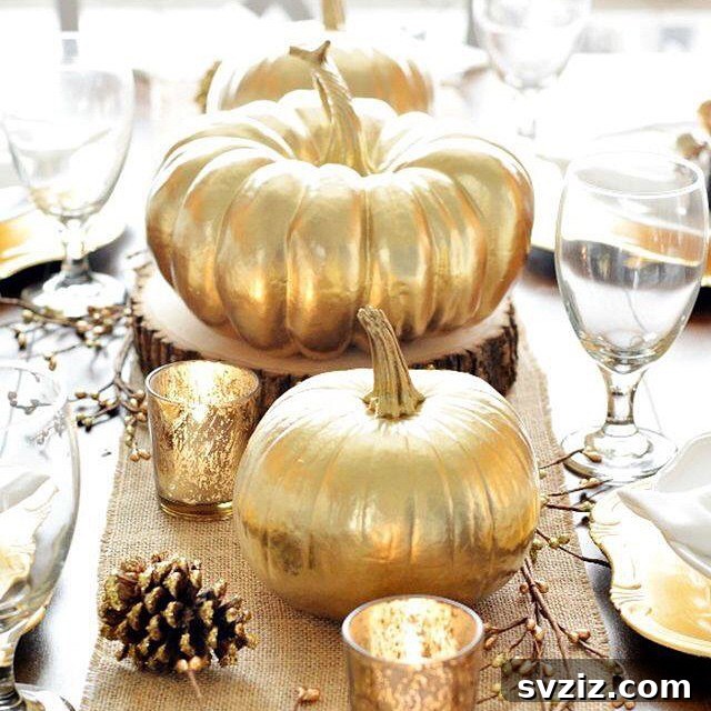Craft the Perfect Feast: 21 DIY Thanksgiving Tablescapes 9 A luxurious Thanksgiving tablescape featuring an abundance of glitzy gold elements, including pumpkins, pinecones, and candle holders.