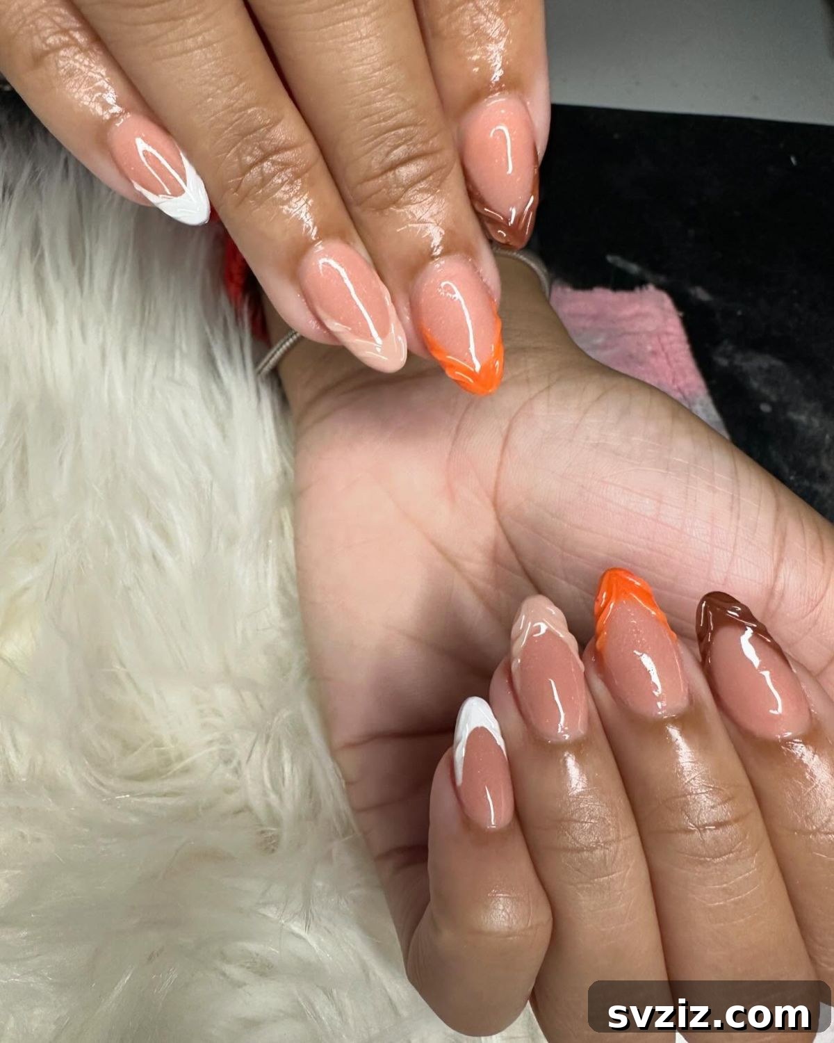 Chic Autumn Almond Nail Ideas 17 Gorgeous almond nails with intricate textured fall-themed French tips in white, nude, orange, and brown hues