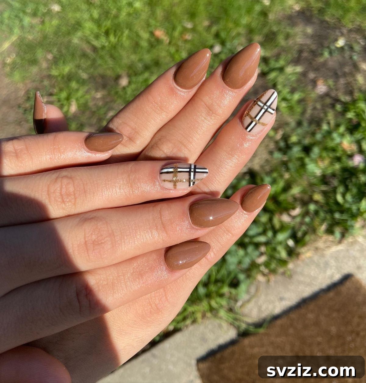 Chic Autumn Almond Nail Ideas 23 Elegant brown almond nails perfectly suited for fall, featuring a cute and stylish checkered accent nail