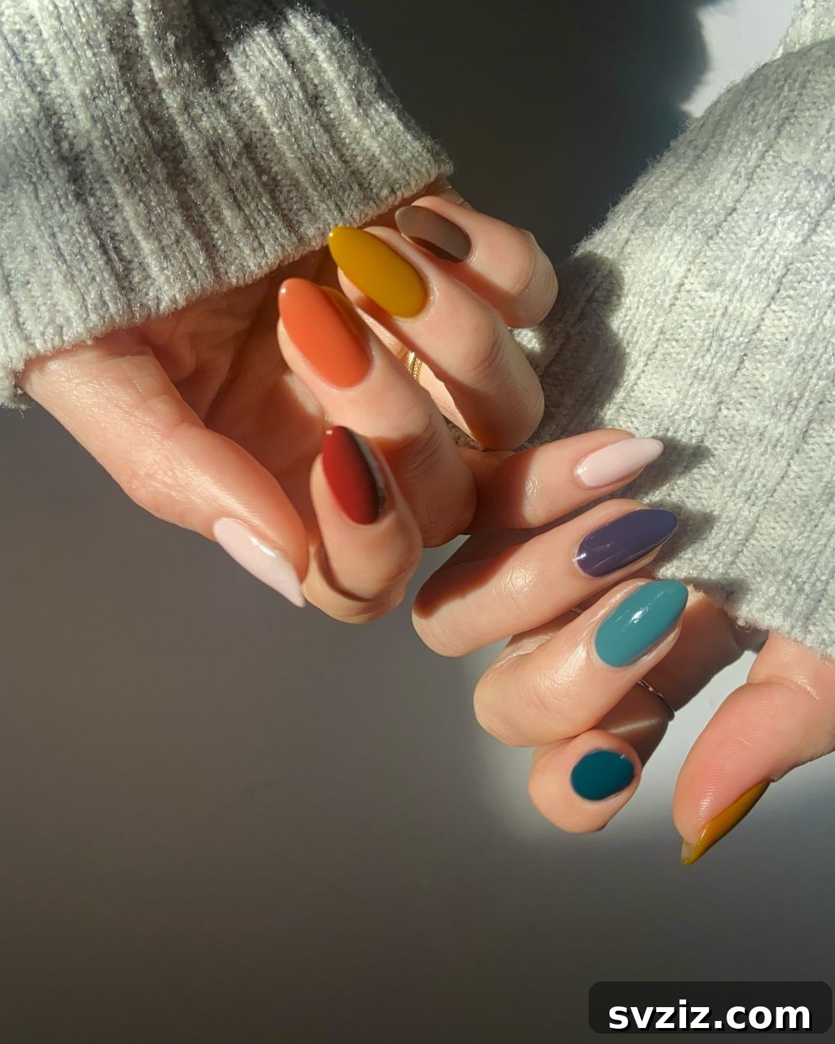 Chic Autumn Almond Nail Ideas 9 Vibrant and playful colorful almond nails with a mix of cute, fun, and popping autumn hues