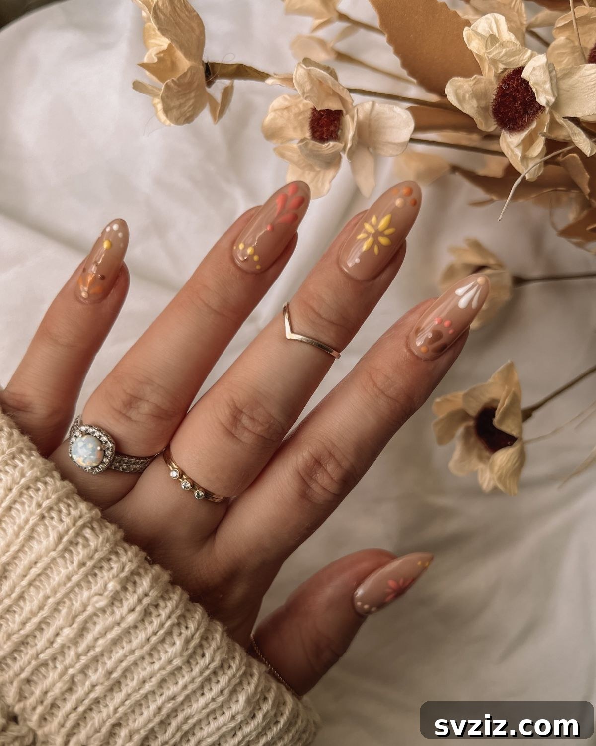 Chic Autumn Almond Nail Ideas 10 Festive colorful floral almond nail art featuring cheerful yellow and coral flowers, perfect for autumn