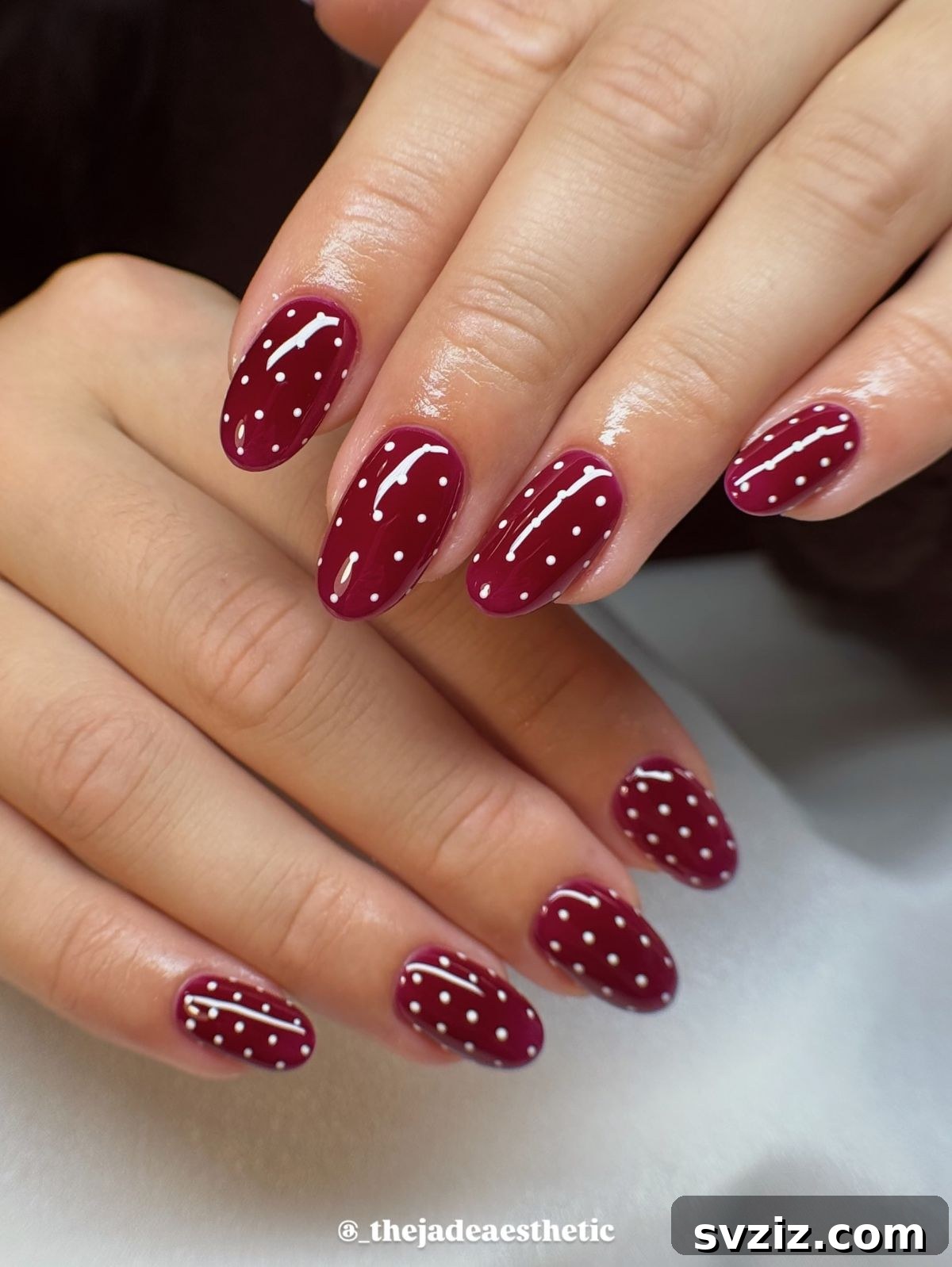 7. Dark Red Polka Dot Nails