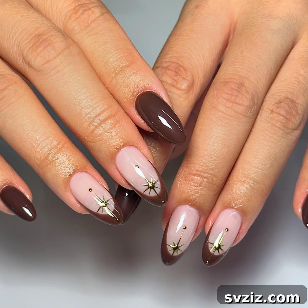 21 Exquisite Almond Nail Designs for Thanksgiving 18 16. Chocolate Brown and Gold Almond Nails with Starbursts