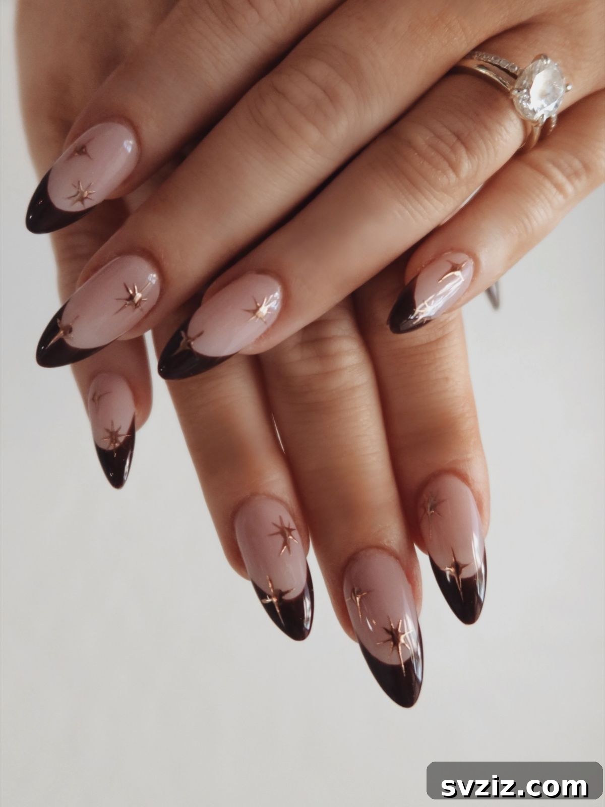 21 Exquisite Almond Nail Designs for Thanksgiving 22 20. Brown French Tips with Starbursts on Almond Nails