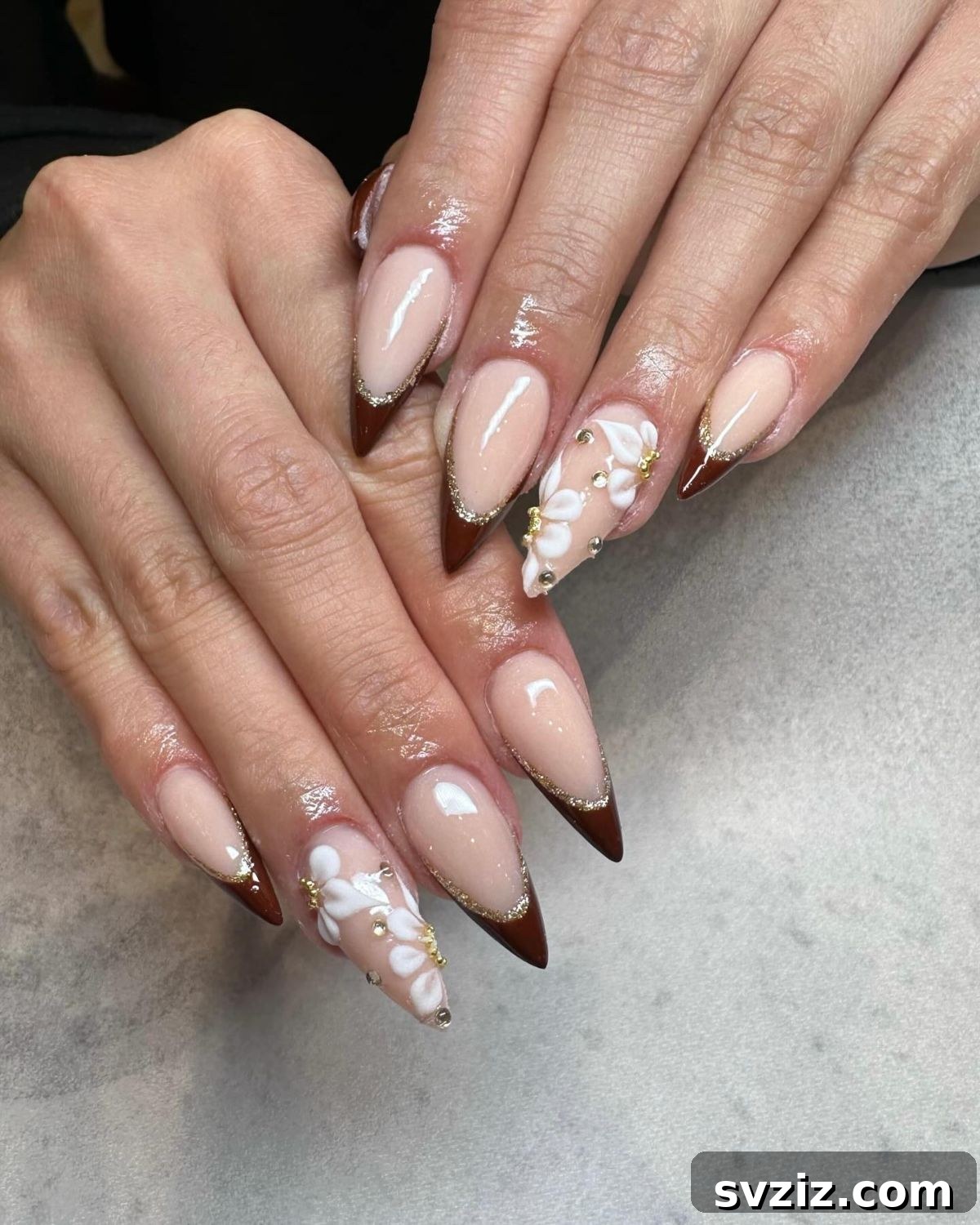 21 Exquisite Almond Nail Designs for Thanksgiving 9 7. Brown Tips with White Floral Accents on Almond Nails