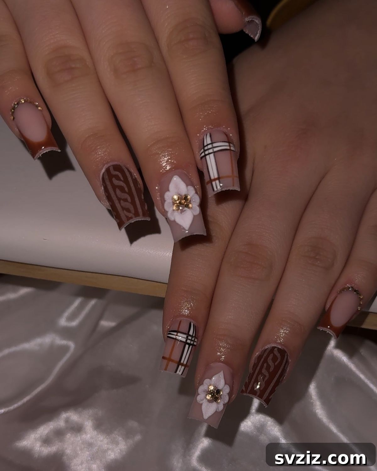 Stunning Thanksgiving Acrylic Nail Art for the Holiday Season 13 Elegant brown and plaid acrylic nails with glamorous rhinestones and creative accent designs, offering varied holiday styling.