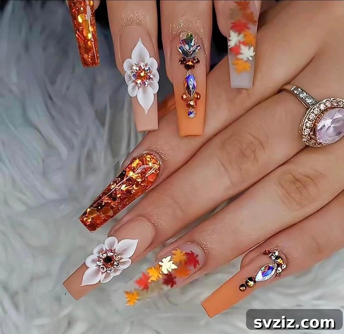 Stunning Thanksgiving Acrylic Nail Art for the Holiday Season 16 Over-the-top blingy Thanksgiving acrylic manicure with gorgeous fall colors, sparkling crystals, and stunning leaf designs.