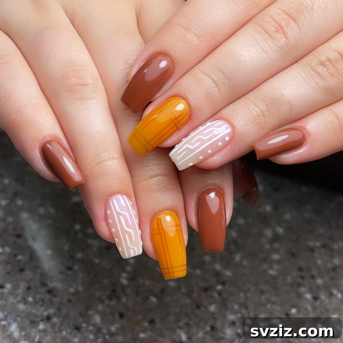 Stunning Thanksgiving Acrylic Nail Art for the Holiday Season 21 Vibrant Thanksgiving acrylic nails showcasing a mix of brown, yellow-orange, and soft nude hues with eye-catching designs.