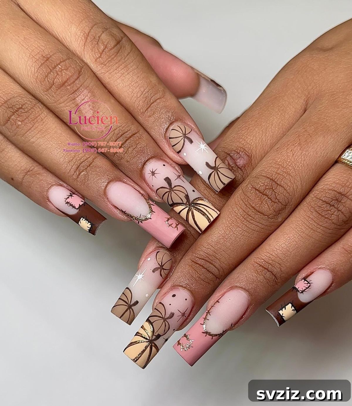 Stunning Thanksgiving Acrylic Nail Art for the Holiday Season 8 Unique Thanksgiving acrylic nails featuring brown and beige pumpkins complemented by glitzy pink and gold French tip accents.