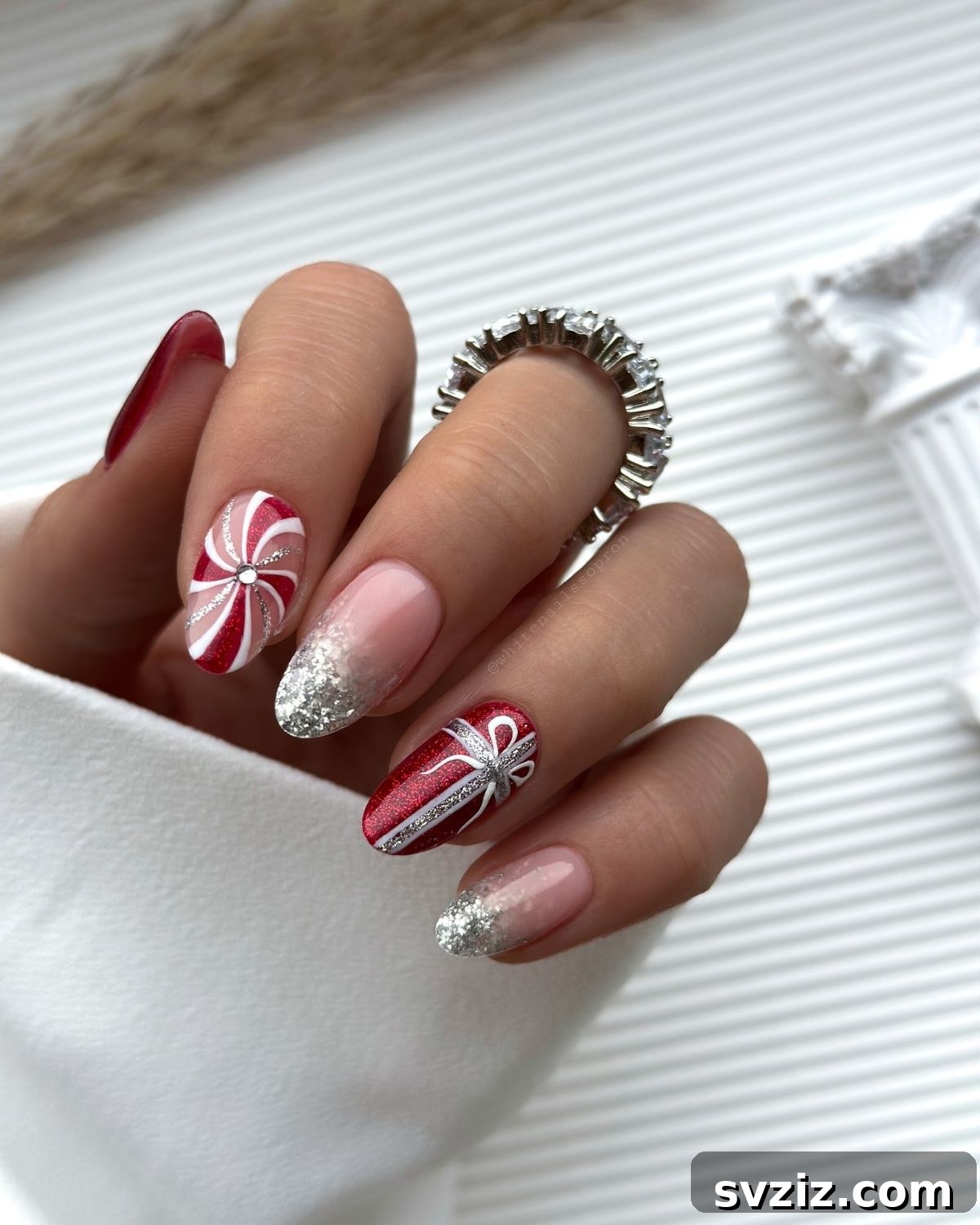 Festive Red Christmas Nail Art Ideas to Inspire Your Holiday Look 14 12. Glitzy Candy Cane Nails