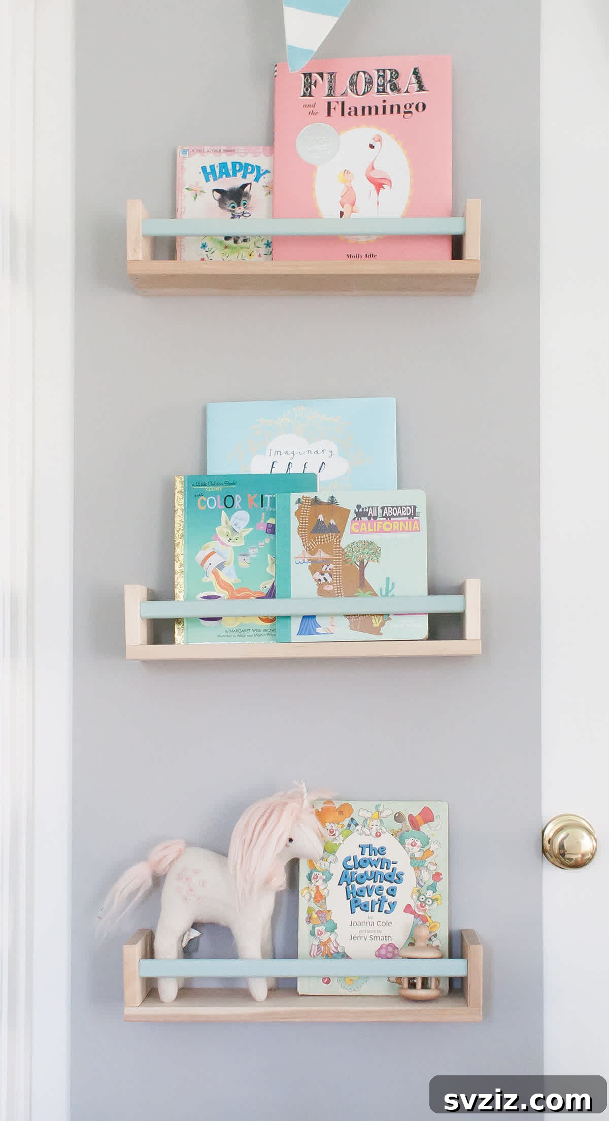 IKEA spice racks painted and mounted on a nursery door as bookshelves