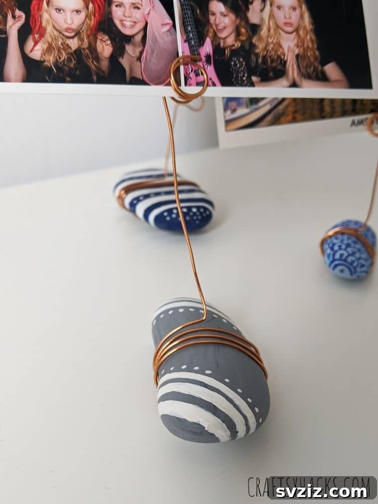 Variety of painted rocks holding photos