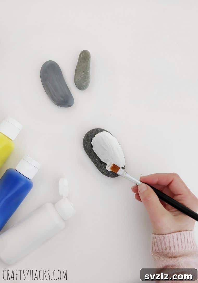 Hand painting a smooth stone with acrylic paint