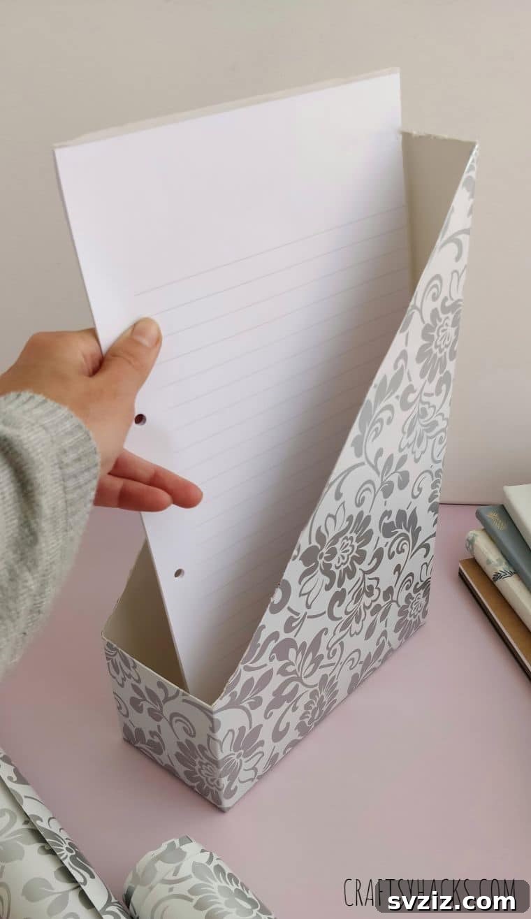Organized papers in a DIY magazine holder, showcasing effective desktop storage in a home office