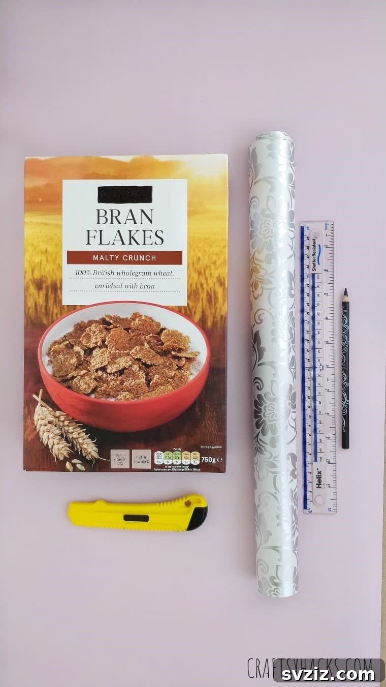 Crafting supplies laid out for making a DIY desk magazine organizer from a cereal box, highlighting household items