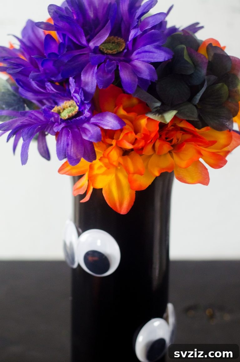 20 Spooktacular Halloween Decorating Ideas 18 DIY Lurking Eye Vase with Googly Eyes for Halloween Decor