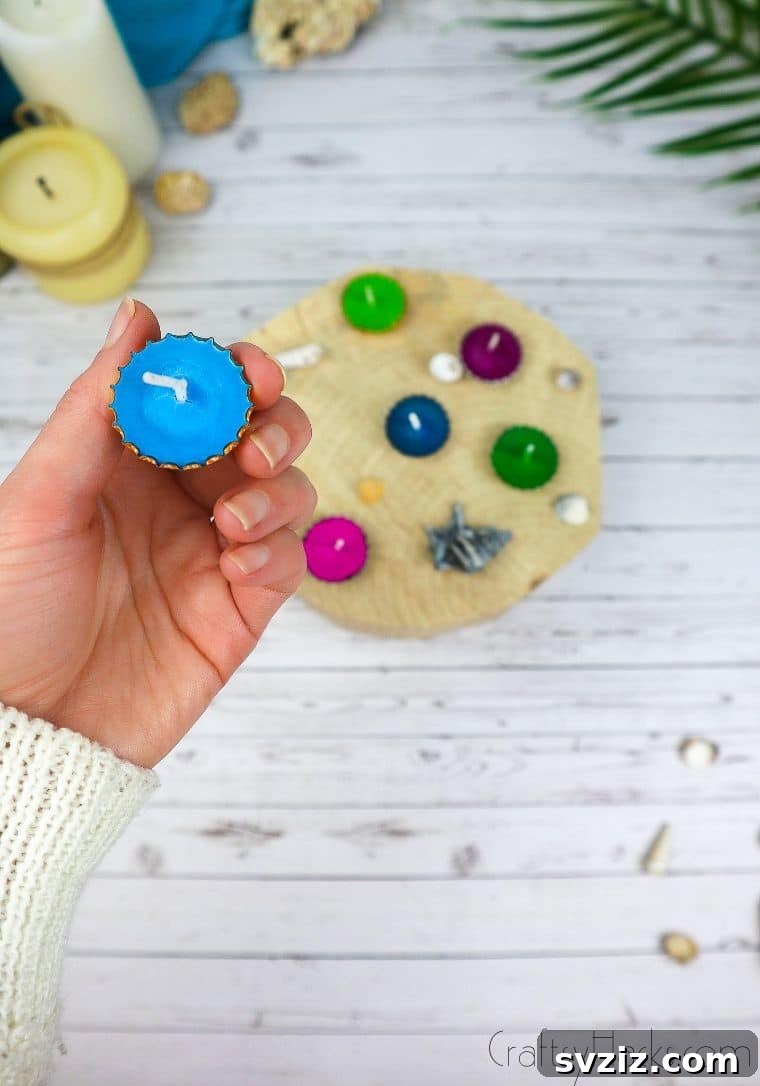 Bottle Cap Tealight Creations 15 A hand holding a blue DIY bottle cap candle, highlighting its simplicity and charm.