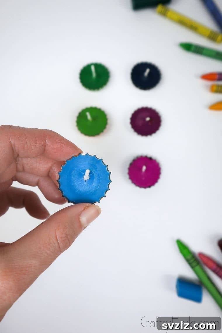 Bottle Cap Tealight Creations 4 A hand gently holding a newly crafted blue bottle cap candle, ready for display.