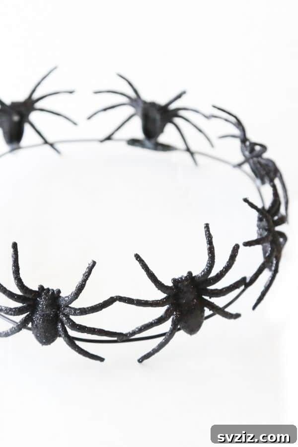 Spin a Web of Wonder: Spider Crafts for Your Little Bug Enthusiast 27 A creative spider crown with plastic spiders and glitter, perfect as a last-minute Halloween costume accessory.