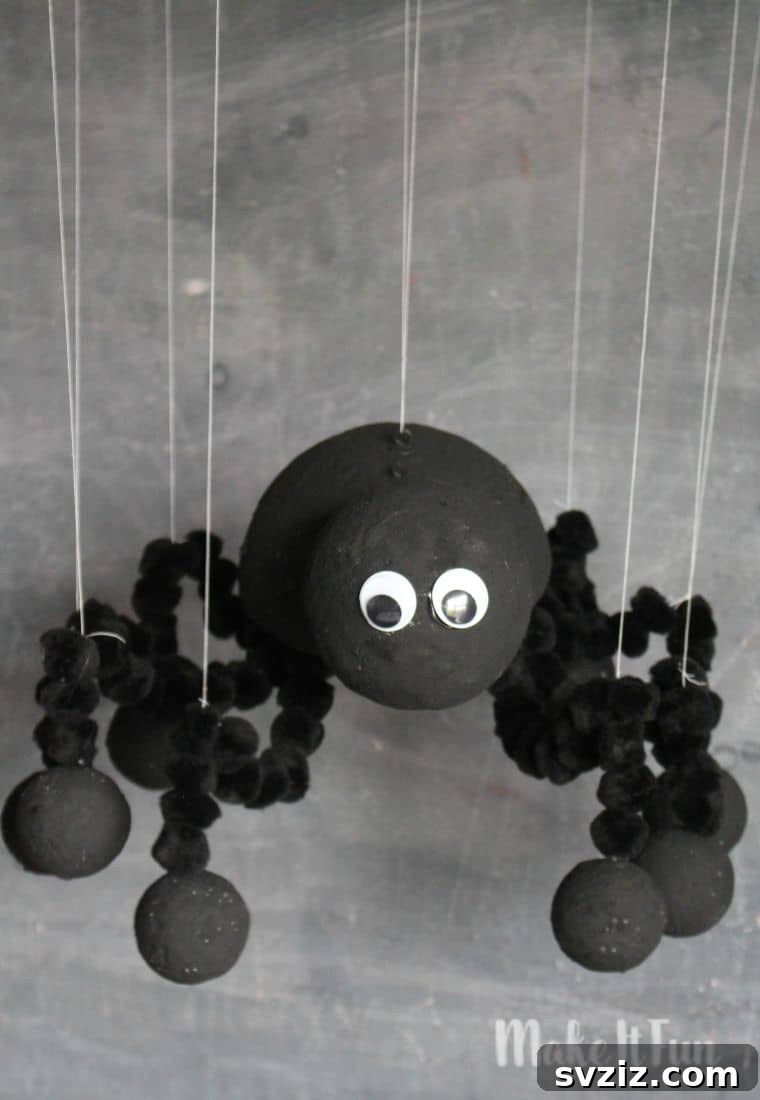 Spin a Web of Wonder: Spider Crafts for Your Little Bug Enthusiast 29 A charming DIY spider marionette made from foam balls and paint stirrers, perfect for imaginative play.