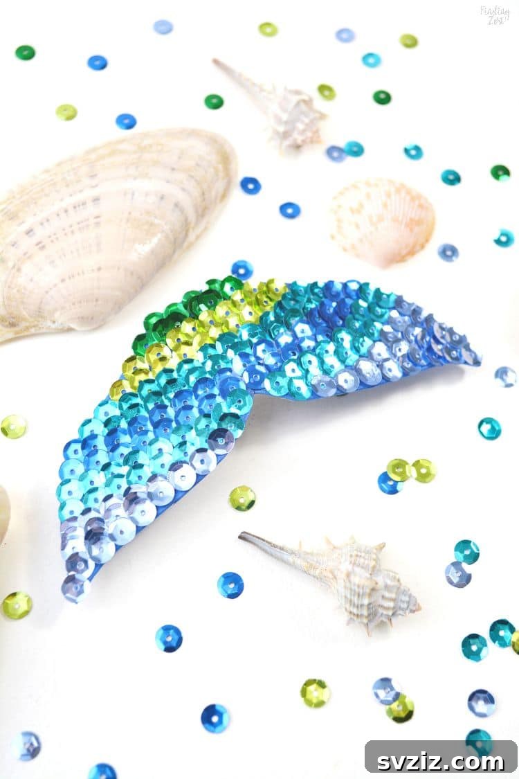 18 Magical Mermaid DIY Projects for Little Ariel Enthusiasts 13 A delicate Mermaid Fin Hair Clip, adorned with sparkling sequins on a blue craft foam base.