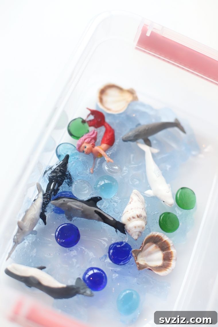 18 Magical Mermaid DIY Projects for Little Ariel Enthusiasts 3 An engaging Ocean Sensory Bin Craft filled with blue elements, shells, and mermaid figures, perfect for stimulating children's senses and imaginative play.