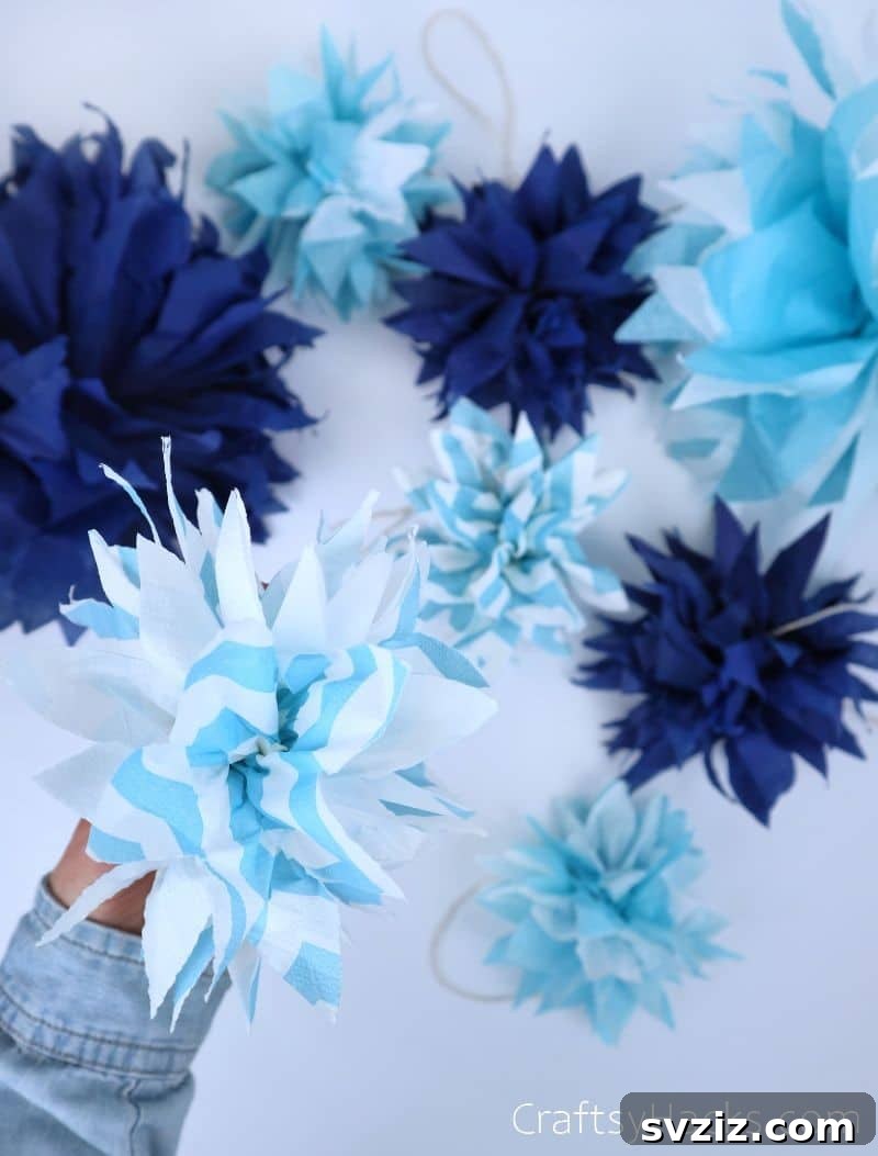 holding blue striped pom pom