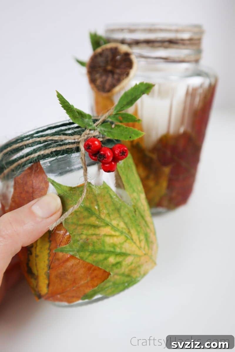 A detailed close-up of a DIY leaf candle holder, emphasizing the texture and intricate placement of the autumn leaves.
