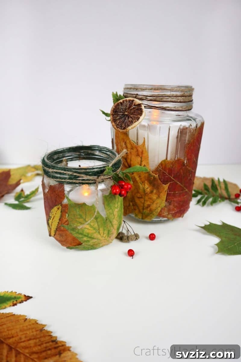 Two completed DIY leaf candle holders, one with richer red tones and the other with warm yellow hues, ready for display.