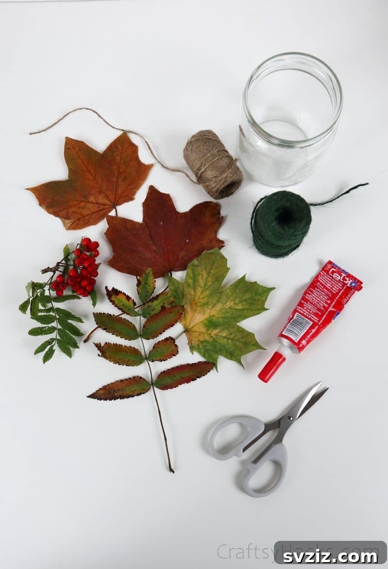 A collection of craft supplies including various autumn leaves, Mod Podge, a jar, and twine, laid out on a wooden surface.
