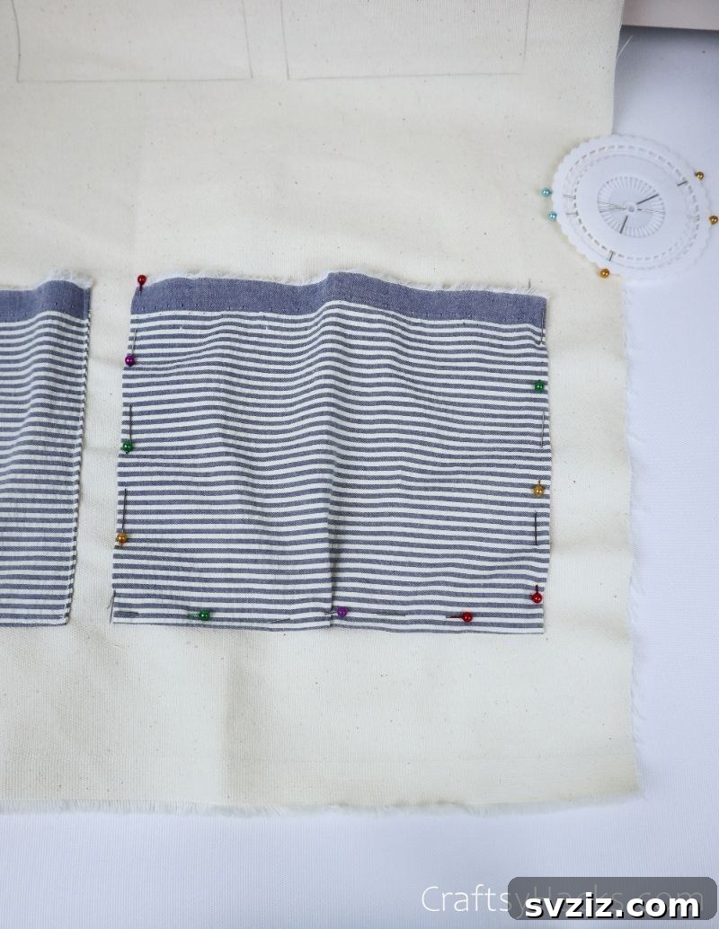 A fabric rectangle with pins all around its edges, ready for sewing