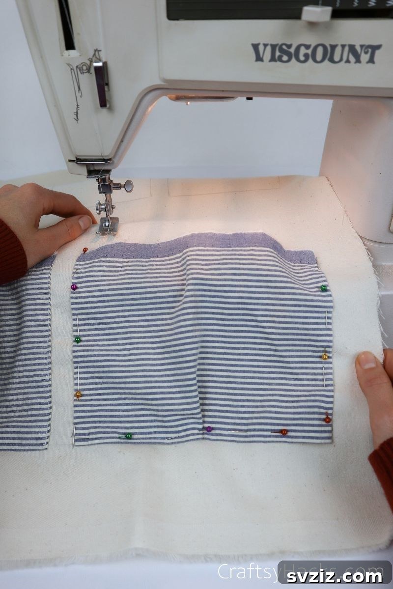 Pinned fabric pocket being sewn on a sewing machine