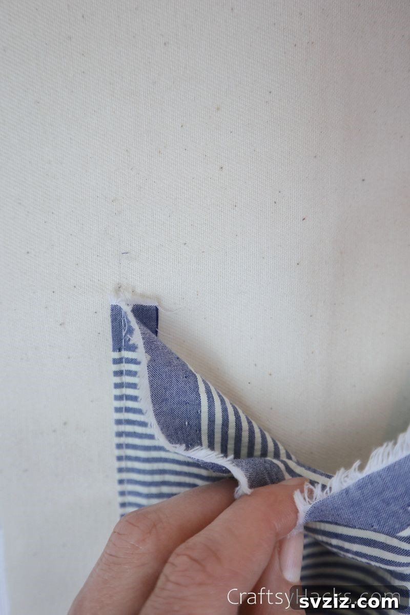 A newly sewn fabric pocket, with a hand demonstrating its opening