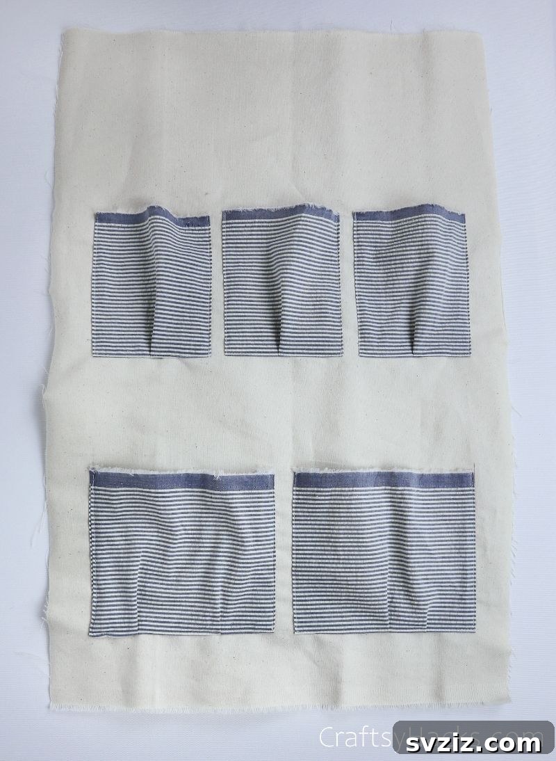 Five pockets neatly sewn onto the fabric organizer base
