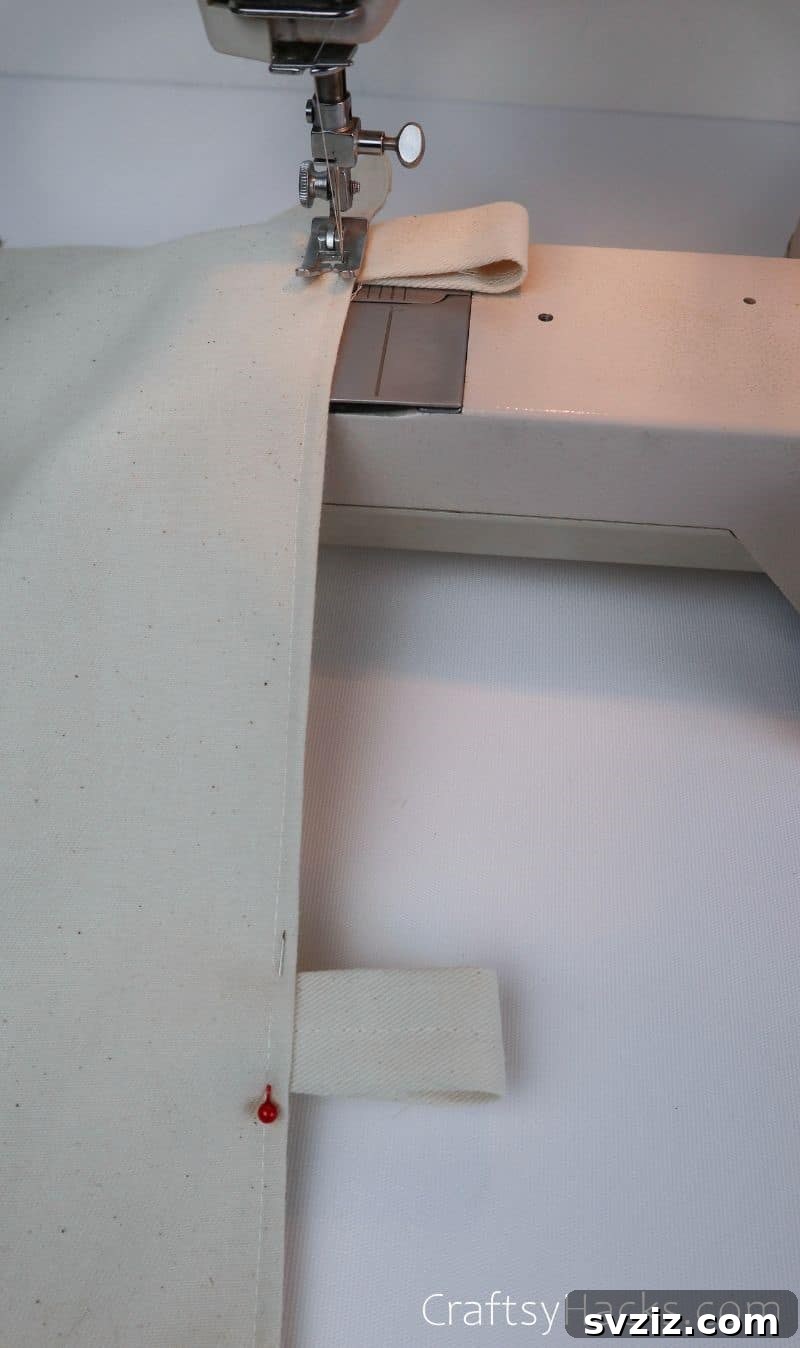 Sewing the fabric straps onto the organizer, securing the wooden dowel