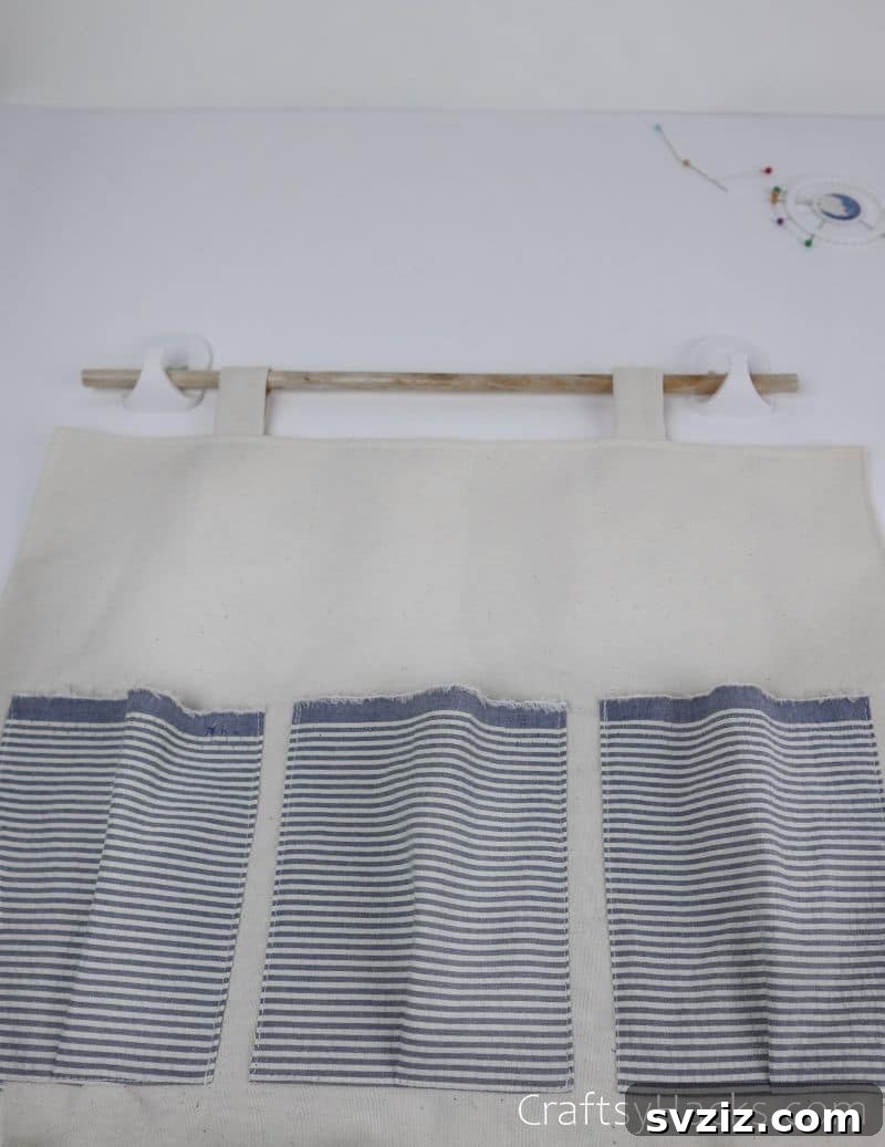 The DIY hanging organizer hanging on a wooden rod