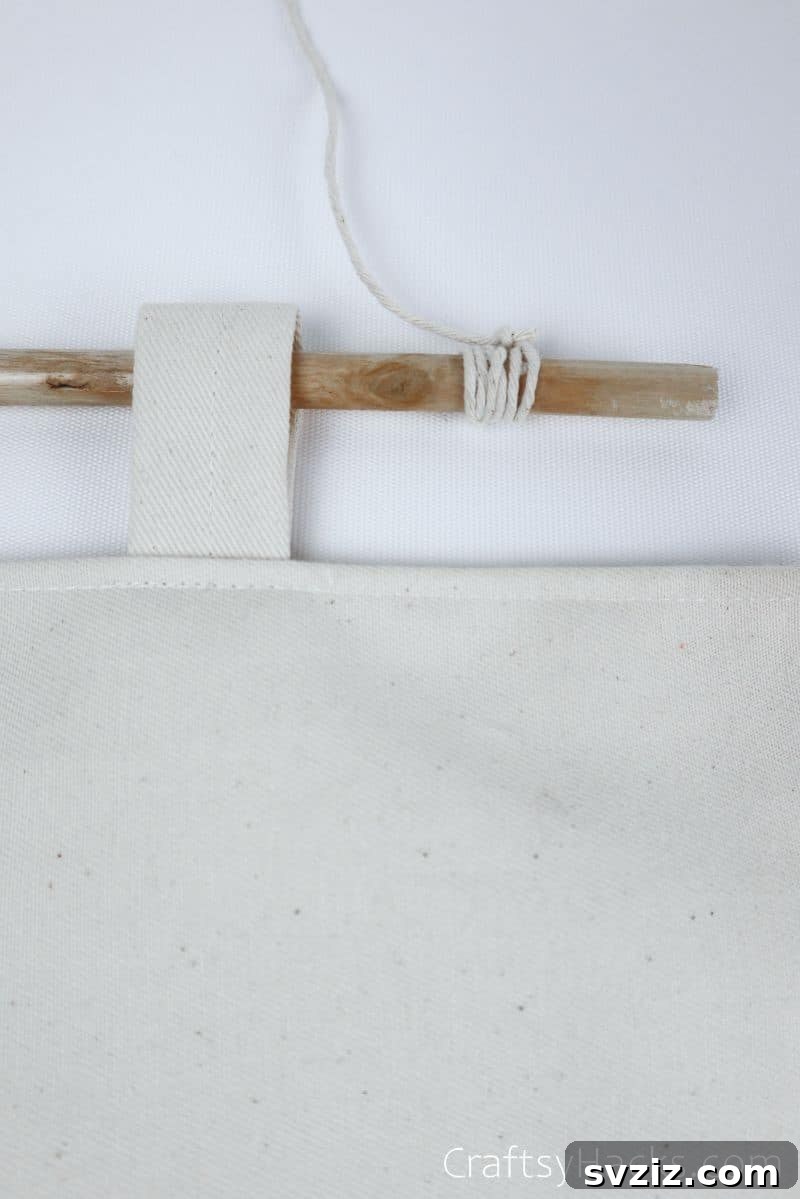 String being tied securely to the wooden stick of the organizer